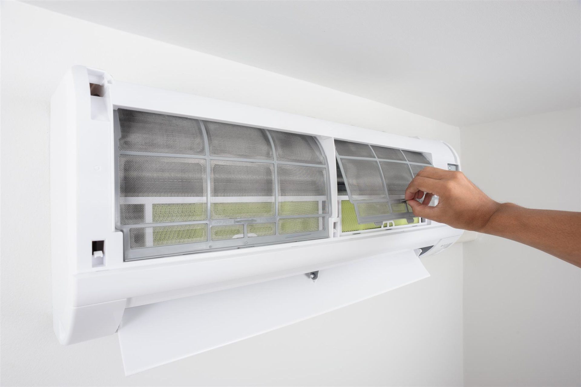 technician cleaning air conditioner